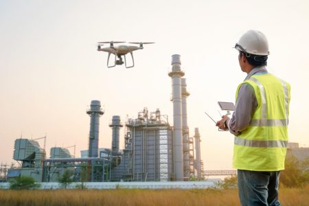 Drone inspection. Operator inspecting construction building  turbine power plant